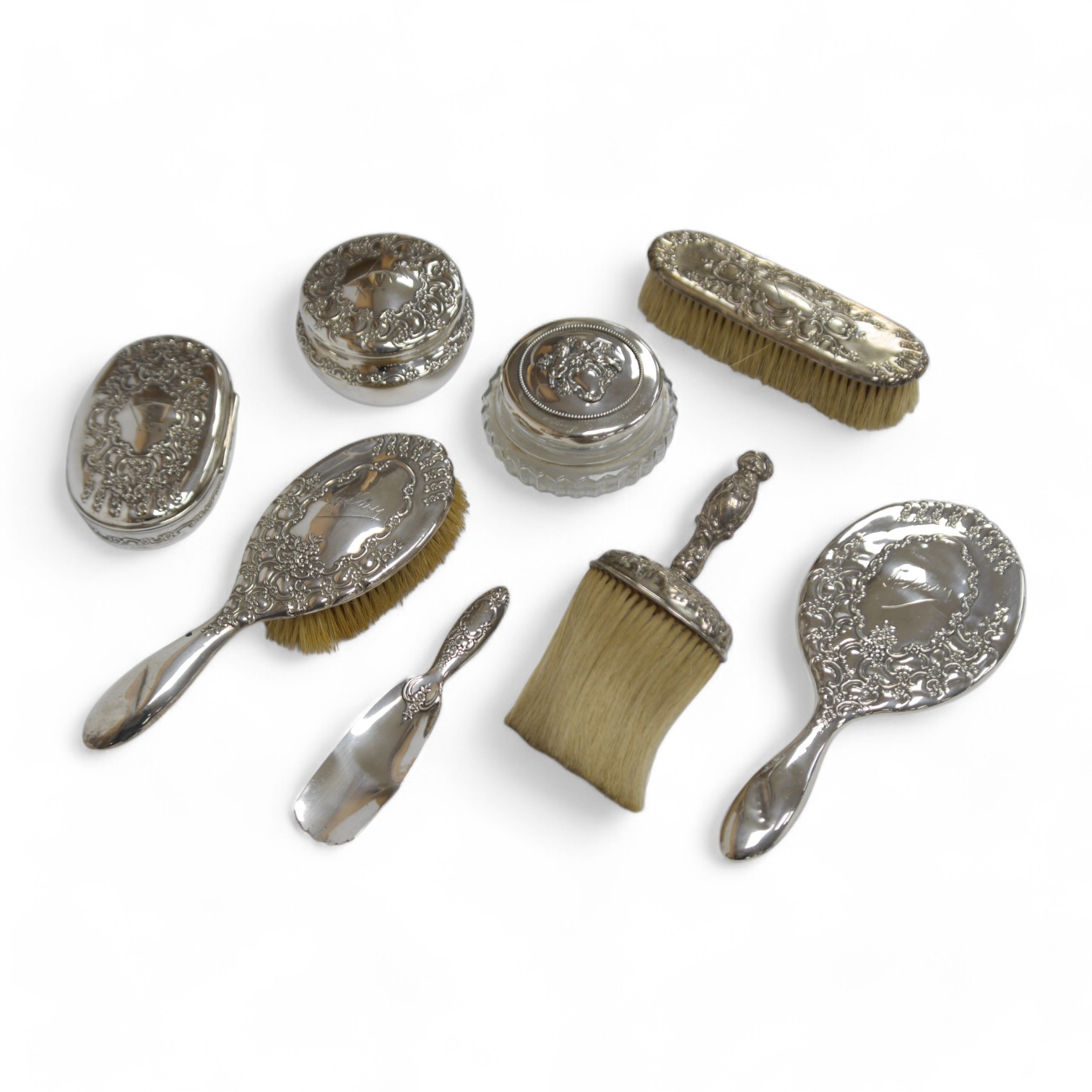 A late 19th/early 20th century Tiffany & Co sterling silver and silver mounted toilet set, comprising a hand mirror, two brushes, a shoe horn, powder jar and compartmental box with engraved inscription, 14cm, all engrave